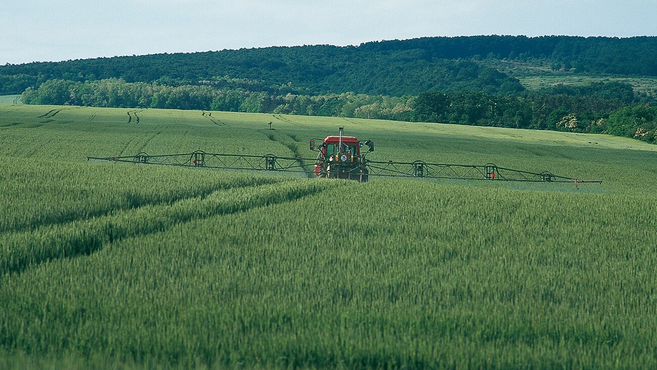 A farmer spraying glyphosate on his field.