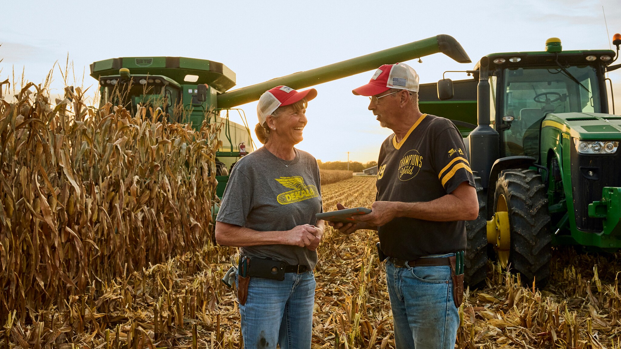 Two farmers discussing their data on an ipad