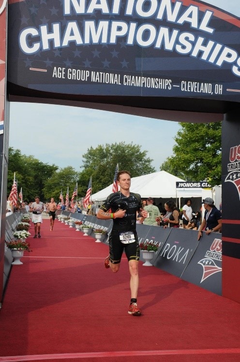 Man crossing finish line at race