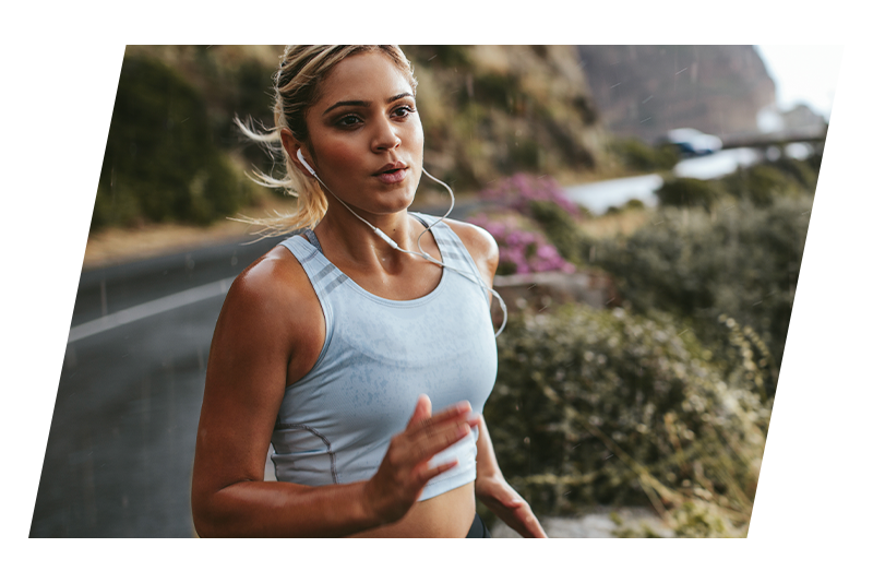 Woman running on mountainside trail
