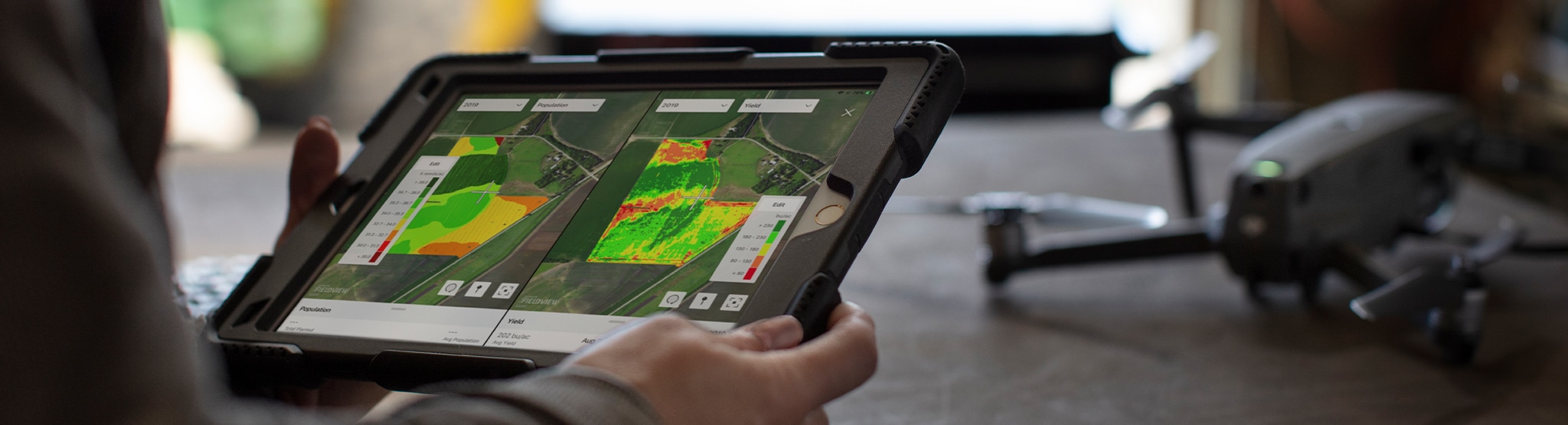 Farmer with tablet and aerial drone