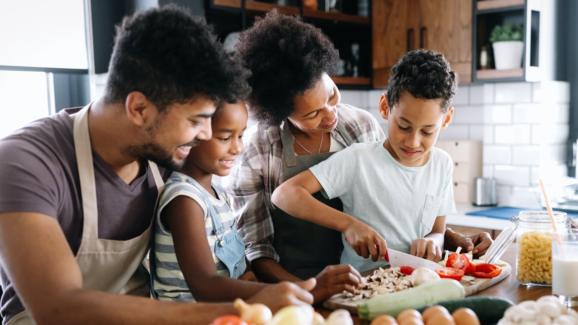 Family of four cooking together