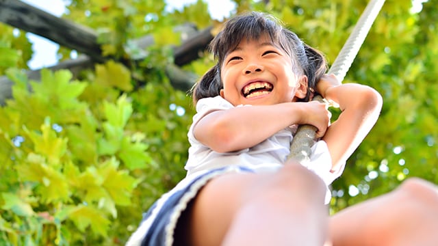 Asian girl playing outside