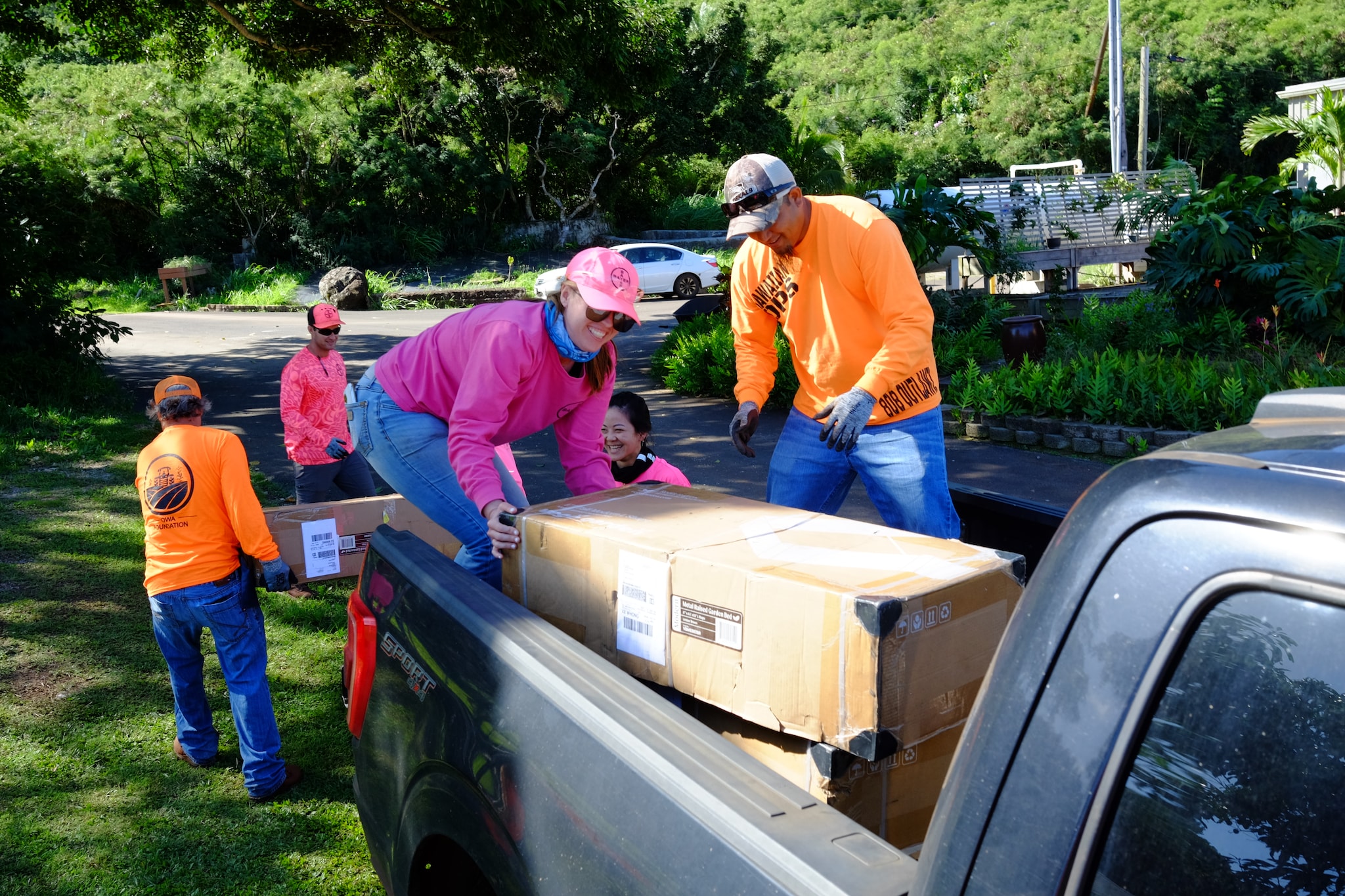 Bayer Hawaii volunteers constructing raised garden beds and installing irrigation at the Pearl Haven community garden.
