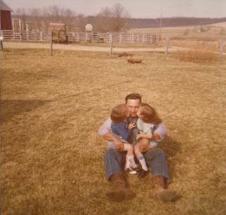 Father holding 2 children